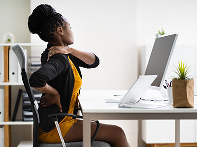 A woman reaching her back because of back pain