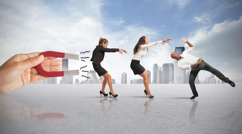 Image of a hand magnetising an employee