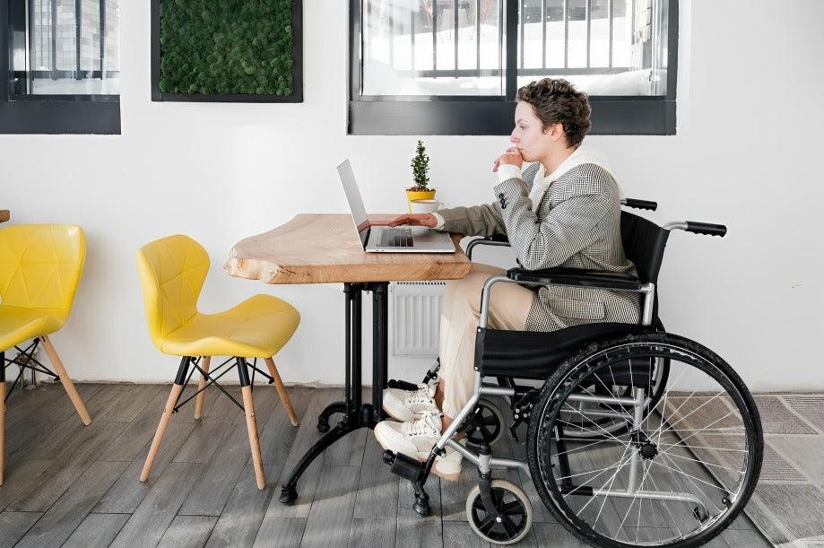 man in a wheel chair working