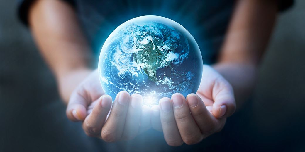 Globe carried by a hand