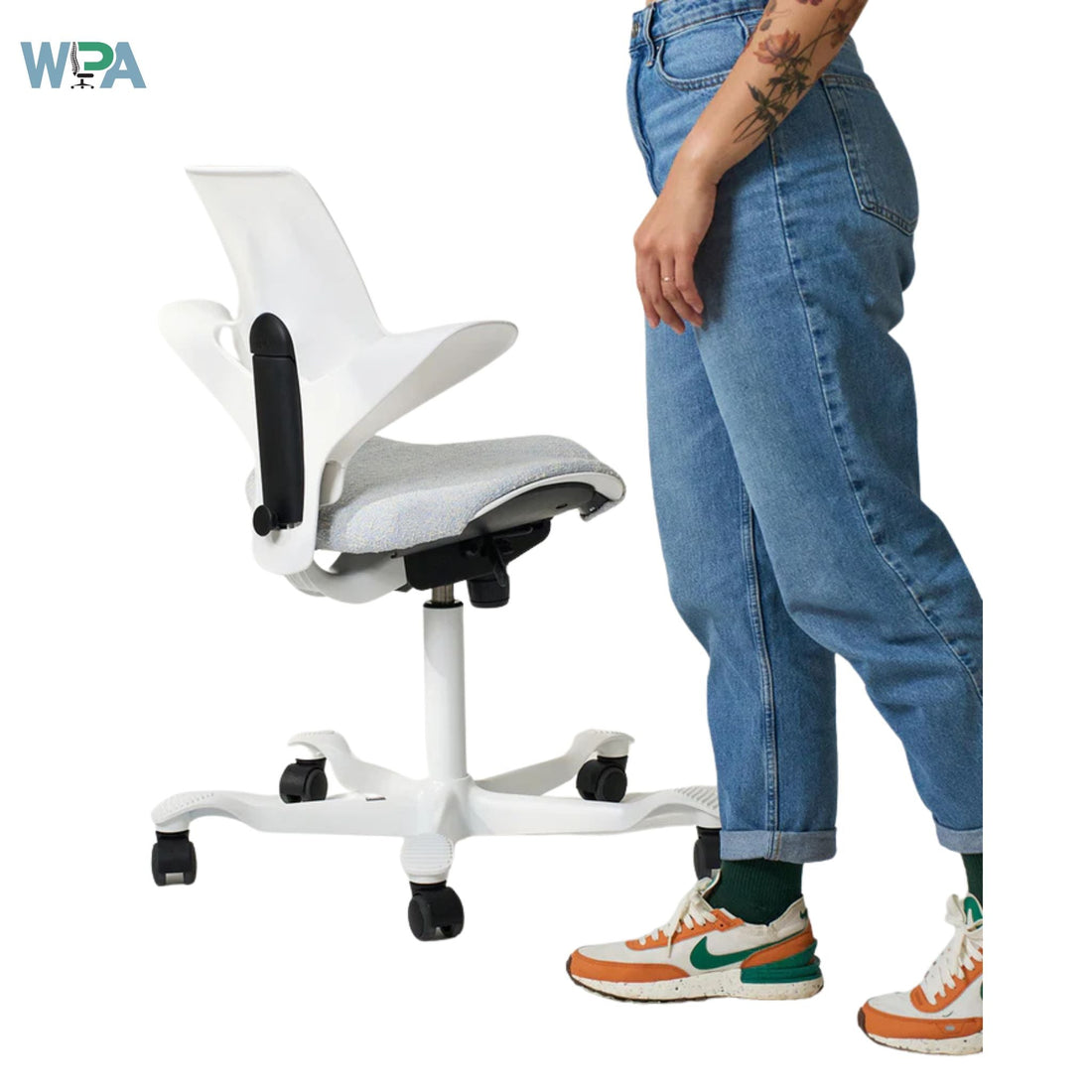 White office chair next to a person wearing blue jeans and colorful sneakers on a white background