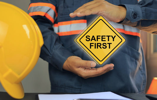 Safety first signage together with a hard hat