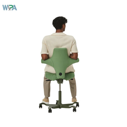 Person using a green adjustable chair on a white background