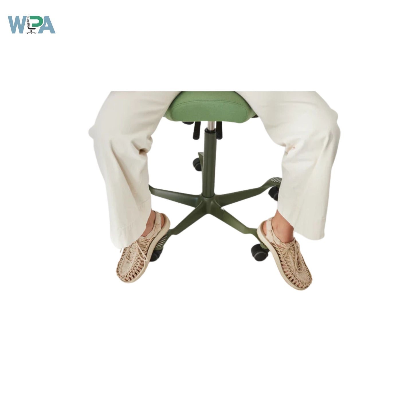 Person sitting on a green office chair with white pants and brown shoes on a white background