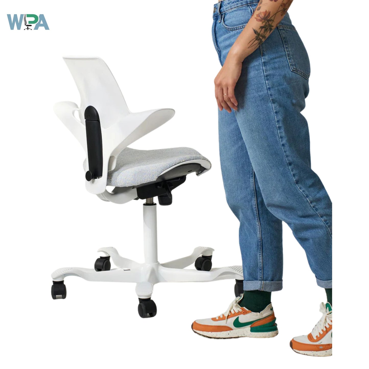 White office chair next to a person wearing blue jeans and colorful sneakers on a white background