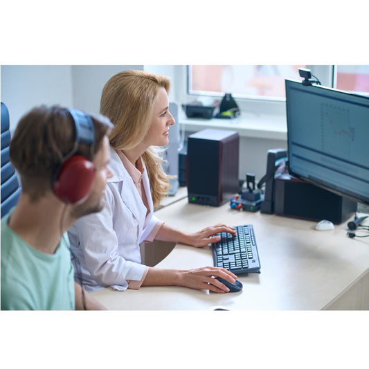 A person wearing headphones during a hearing assessment session.