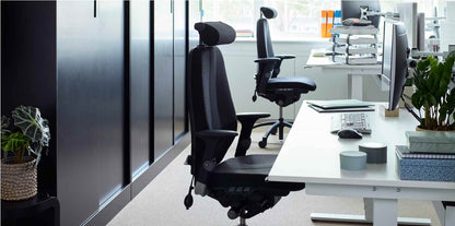 Modern office setup with ergonomic chairs and a desk.